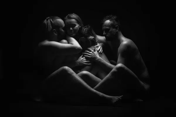 Group of people in a warm embrace — many forms of love and connection